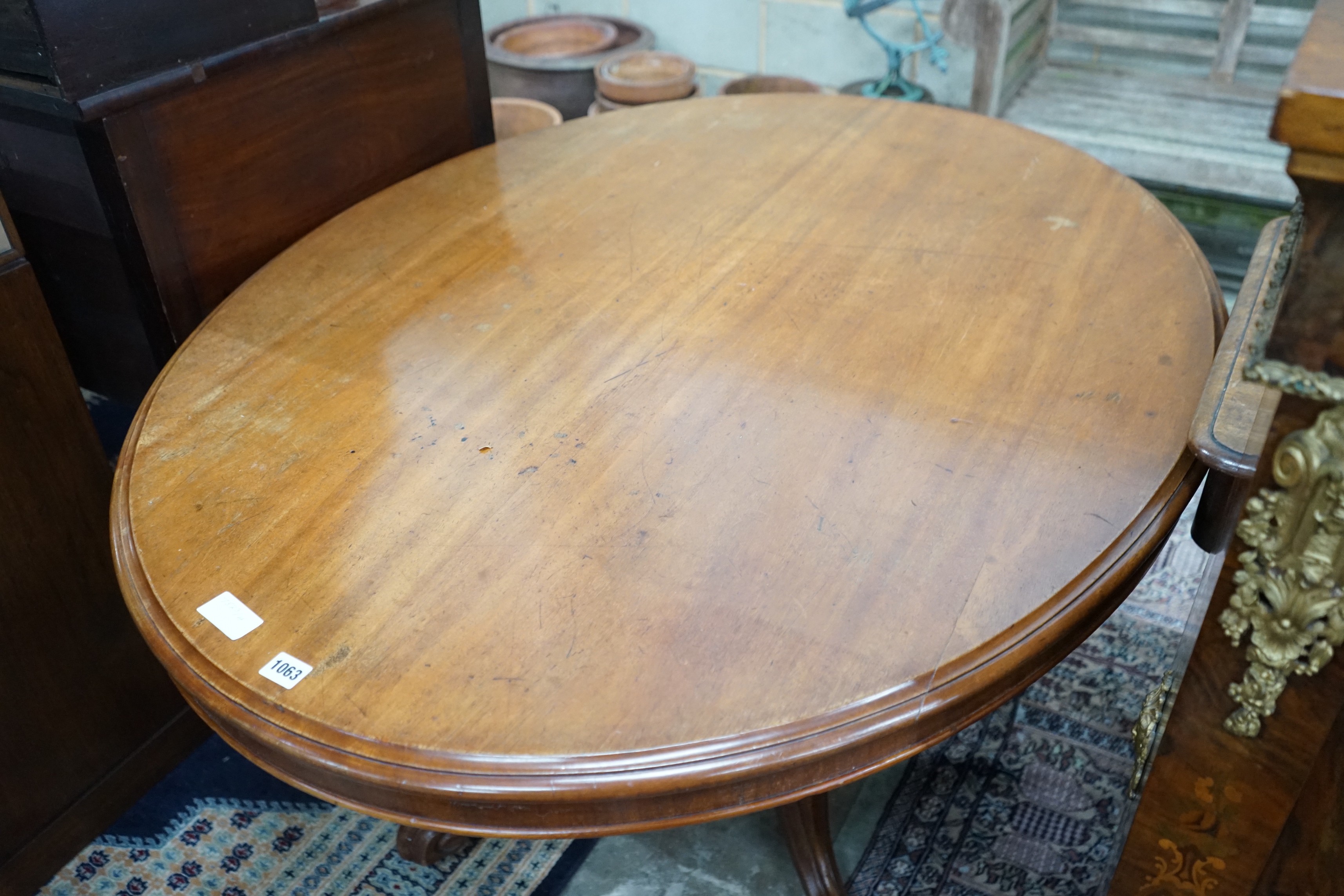 A Victorian mahogany oval tilt-top loo table width 134cms, depth 104, height 72cms.